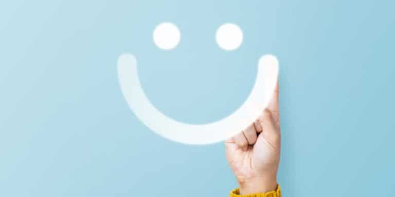 Smiling face on light blue background